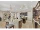 Open kitchen featuring a center island, dark cabinets, and stainless steel appliances at 261 Portofino Dr, North Venice, FL 34275