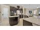 Modern kitchen with dark wood cabinetry, granite countertops, stainless steel appliances, and two islands at 261 Portofino Dr, North Venice, FL 34275