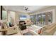 Bright living room with a ceiling fan, sliding glass doors to outdoor patio, and an adjacent staircase at 261 Portofino Dr, North Venice, FL 34275