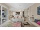 Open floor plan living room featuring tile floors, modern furnishings, and natural light throughout at 261 Portofino Dr, North Venice, FL 34275