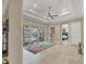 Spacious living room with decorative tray ceiling, sliding glass doors to the pool, and neutral walls at 261 Portofino Dr, North Venice, FL 34275