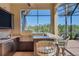 Outdoor kitchen offers stainless steel appliances, granite countertops and a view of the pool at 261 Portofino Dr, North Venice, FL 34275