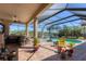 Spacious outdoor living area with a covered patio, a built-in grill, and a refreshing pool at 261 Portofino Dr, North Venice, FL 34275