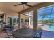 The outdoor patio area features comfortable seating, ceiling fans, and access to the pool at 261 Portofino Dr, North Venice, FL 34275