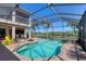 Relaxing screened-in pool area featuring a hot tub, outdoor seating and a serene view at 261 Portofino Dr, North Venice, FL 34275