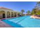 Beautiful community lap pool surrounded by palm trees and lounge chairs for relaxation at 261 Portofino Dr, North Venice, FL 34275