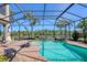 Relaxing screened-in pool area featuring a hot tub, and a serene view of the natural landscape at 261 Portofino Dr, North Venice, FL 34275