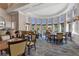 Elegant restaurant featuring a bar, dining tables, chairs, large windows, and stylish decor at 261 Portofino Dr, North Venice, FL 34275