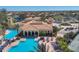 Aerial view of community pool with seating areas, palm trees, and views of the neighborhood at 261 Portofino Dr, North Venice, FL 34275