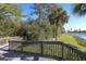 Scenic wooden deck offers picturesque views of the lush greenery and tranquil waterside community at 261 Portofino Dr, North Venice, FL 34275
