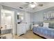 Well-lit bedroom featuring a nautical painting, ceiling fan, comfortable daybed, and an en suite bathroom at 2808 60Th W Ave # 1603, Bradenton, FL 34207