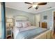 Bright bedroom boasts a comfortable bed, ceiling fan, wood floors and relaxing decor at 2808 60Th W Ave # 1603, Bradenton, FL 34207