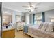 Bright, relaxing bedroom with comfortable bed, neutral walls, fan, and wood flooring at 2808 60Th W Ave # 1603, Bradenton, FL 34207