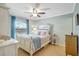 Cozy bedroom features a comfortable bed, ceiling fan, natural light and wood floors at 2808 60Th W Ave # 1603, Bradenton, FL 34207