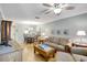 Open concept living and dining space featuring neutral paint, ceiling fan and wood floors at 2808 60Th W Ave # 1603, Bradenton, FL 34207