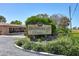Community sign for Bayshore Village is surrounded by lush greenery near the property on a sunny day at 2808 60Th W Ave # 1603, Bradenton, FL 34207