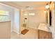 Bright bathroom with glass-enclosed shower, a wooden stool, and a vanity with double sinks and marble countertop at 2904 N Ola Ave, Tampa, FL 33602