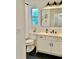 Modern bathroom features a white vanity with a solid surface counter, black hardware and decorative accents at 2904 N Ola Ave, Tampa, FL 33602