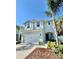 Charming two-story home with a well-manicured lawn, white trim, and an attached two car garage at 2904 N Ola Ave, Tampa, FL 33602