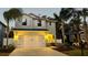 Beautiful two-story home illuminated at dusk, featuring a spacious driveway and a lush front yard at 2904 N Ola Ave, Tampa, FL 33602
