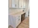 Stylish kitchen featuring a wine cooler, sleek cabinets and quartz countertops at 2904 N Ola Ave, Tampa, FL 33602