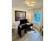 Bright home office featuring modern desk, large window, hardwood floors, and contemporary artwork at 2904 N Ola Ave, Tampa, FL 33602
