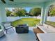 Relaxing outdoor patio area with a fire pit, cozy seating, and view of the landscaped backyard at 2904 N Ola Ave, Tampa, FL 33602