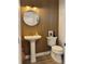 Charming powder room with wood slat wall, pedestal sink, and modern fixtures offers a stylish touch at 2904 N Ola Ave, Tampa, FL 33602