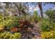 Picturesque garden path with lush greenery, decorative lighting, and beautiful foliage at 3408 Brookridge Ln, Parrish, FL 34219
