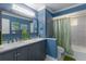Stylish bathroom with a double vanity, decorative mirror, and a tub-shower combination at 3408 Brookridge Ln, Parrish, FL 34219