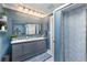 Stylish bathroom with blue walls, double vanity, and modern shower at 3408 Brookridge Ln, Parrish, FL 34219