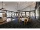 Open dining area with many tables, expansive windows, a dark patterned carpet and a seating area at 3408 Brookridge Ln, Parrish, FL 34219