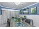 Well-appointed dining room with modern chandelier, seating for eight, and decorative leaf accents at 3408 Brookridge Ln, Parrish, FL 34219