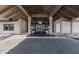 View of a building entrance featuring a covered walkway with exposed wood beams and stone pillars at 3408 Brookridge Ln, Parrish, FL 34219