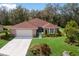 Charming single-Gathering home with manicured lawn, landscaping, and an attached two-car garage at 3408 Brookridge Ln, Parrish, FL 34219