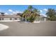 Exterior view of a building with palm trees in the middle of the parking area, and a circular driveway at 3408 Brookridge Ln, Parrish, FL 34219