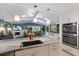 Kitchen island with sink and dishwasher overlooks a cozy fireplace in the living room at 3408 Brookridge Ln, Parrish, FL 34219