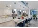 Bright, modern kitchen features a large island with seating, pendant lighting, and stainless steel appliances at 3408 Brookridge Ln, Parrish, FL 34219