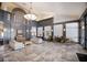 Open lobby area with decorative stone flooring, a large chandelier, and multiple seating options at 3408 Brookridge Ln, Parrish, FL 34219