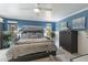 Bright and airy main bedroom featuring a ceiling fan, modern furniture, and stylish decorations at 3408 Brookridge Ln, Parrish, FL 34219