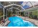 Beautiful pool with screen enclosure, patio, and relaxing seating area for luxurious outdoor living at 3408 Brookridge Ln, Parrish, FL 34219