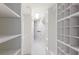 Bright walk-in closet with white shelving for organized storage solutions at 3408 Brookridge Ln, Parrish, FL 34219