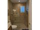 Contemporary bathroom with glass-enclosed shower, tiled walls, and modern fixtures at 3572 Peace River Dr, Punta Gorda, FL 33983