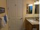 Well-lit bathroom featuring a modern vanity, granite countertops, and neutral tones at 3572 Peace River Dr, Punta Gorda, FL 33983