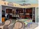 Open kitchen with island, breakfast bar, pendant lights, and wood cabinetry, leading to an outdoor patio area at 3572 Peace River Dr, Punta Gorda, FL 33983