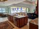 Spacious kitchen featuring a large center island with a sink, seating, and pendant lighting at 3572 Peace River Dr, Punta Gorda, FL 33983