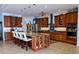 Gourmet kitchen with custom cabinets, stainless steel appliances, and a center island with seating at 3572 Peace River Dr, Punta Gorda, FL 33983