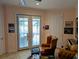Inviting living room with French doors to the lanai, plus stylish seating and decor at 3572 Peace River Dr, Punta Gorda, FL 33983