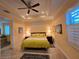 Cozy main bedroom with tray ceilings, neutral walls, tile floors and matching bedside lamps at 3572 Peace River Dr, Punta Gorda, FL 33983