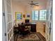 Home office with a large desk, chair, and natural light from shuttered windows, creating a workspace at 3572 Peace River Dr, Punta Gorda, FL 33983